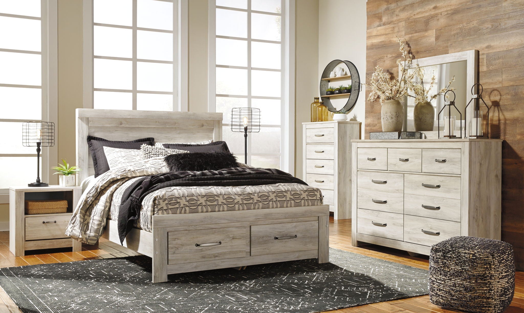 Beige platform bed with two storage drawers, tall headboard, and patterned bedding