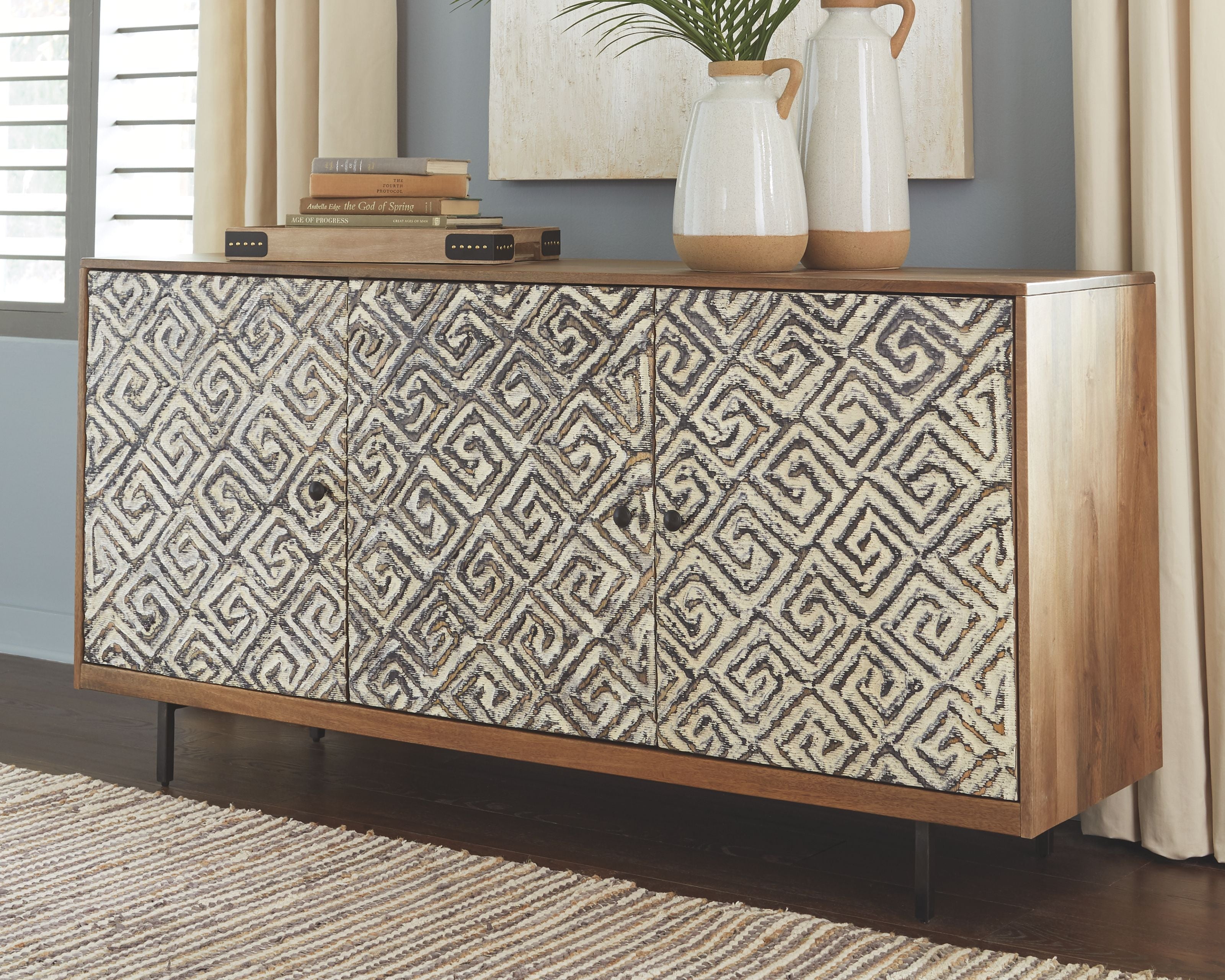 Accent cabinet with geometric fabric doors and wood base, three compartments with knobs