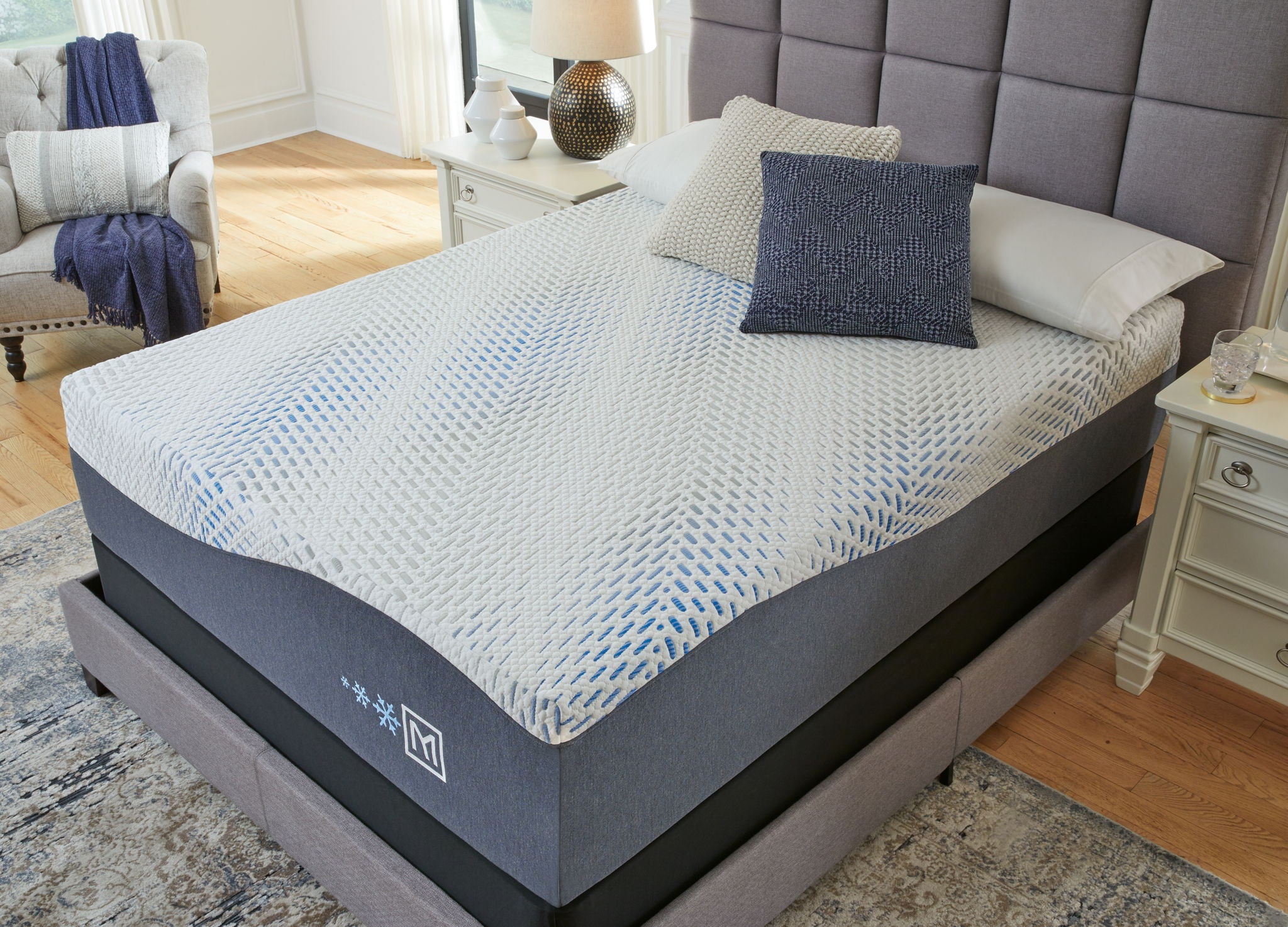 Hybrid gel latex mattress with white patterned top and blue upholstered base