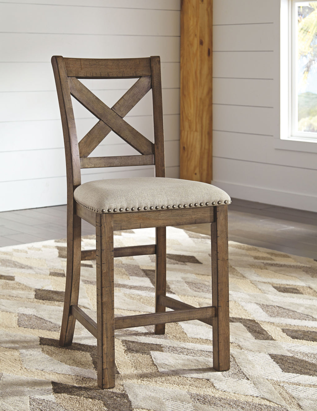 Cross-back dining chair with upholstered seat and nailhead trim on dark wood frame