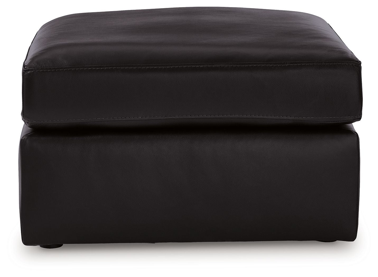 Black upholstered ottoman with rounded top and stitched paneling