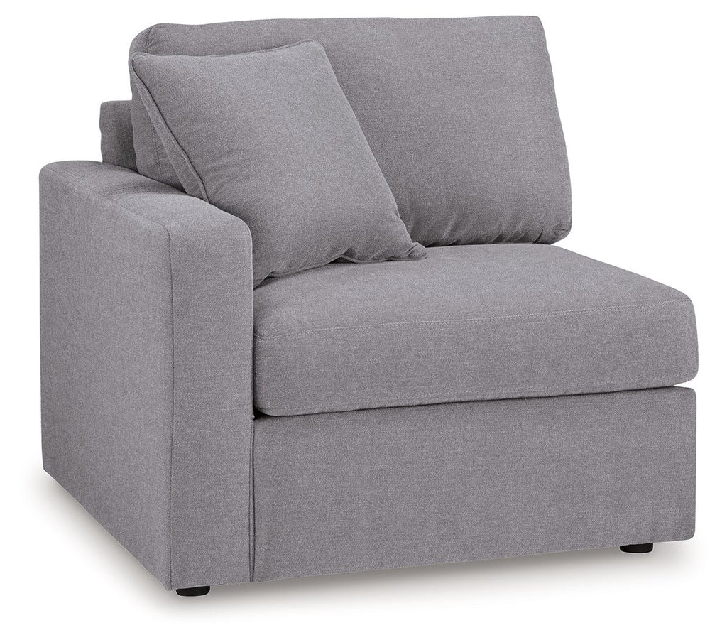 Granite gray corner chair with padded back cushions and armrests
