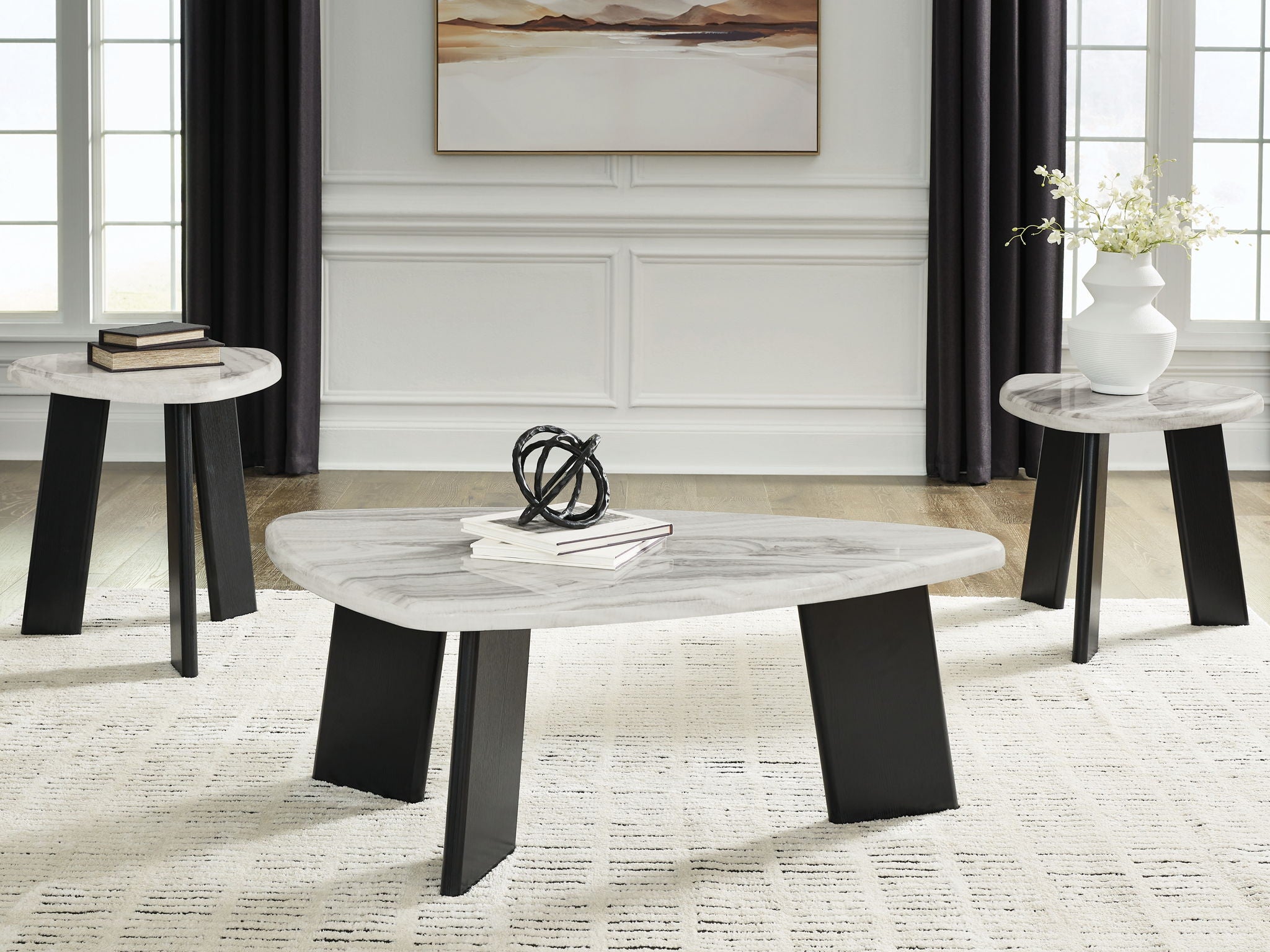 Occasional table set (3) with round gray tops and black legs in living room