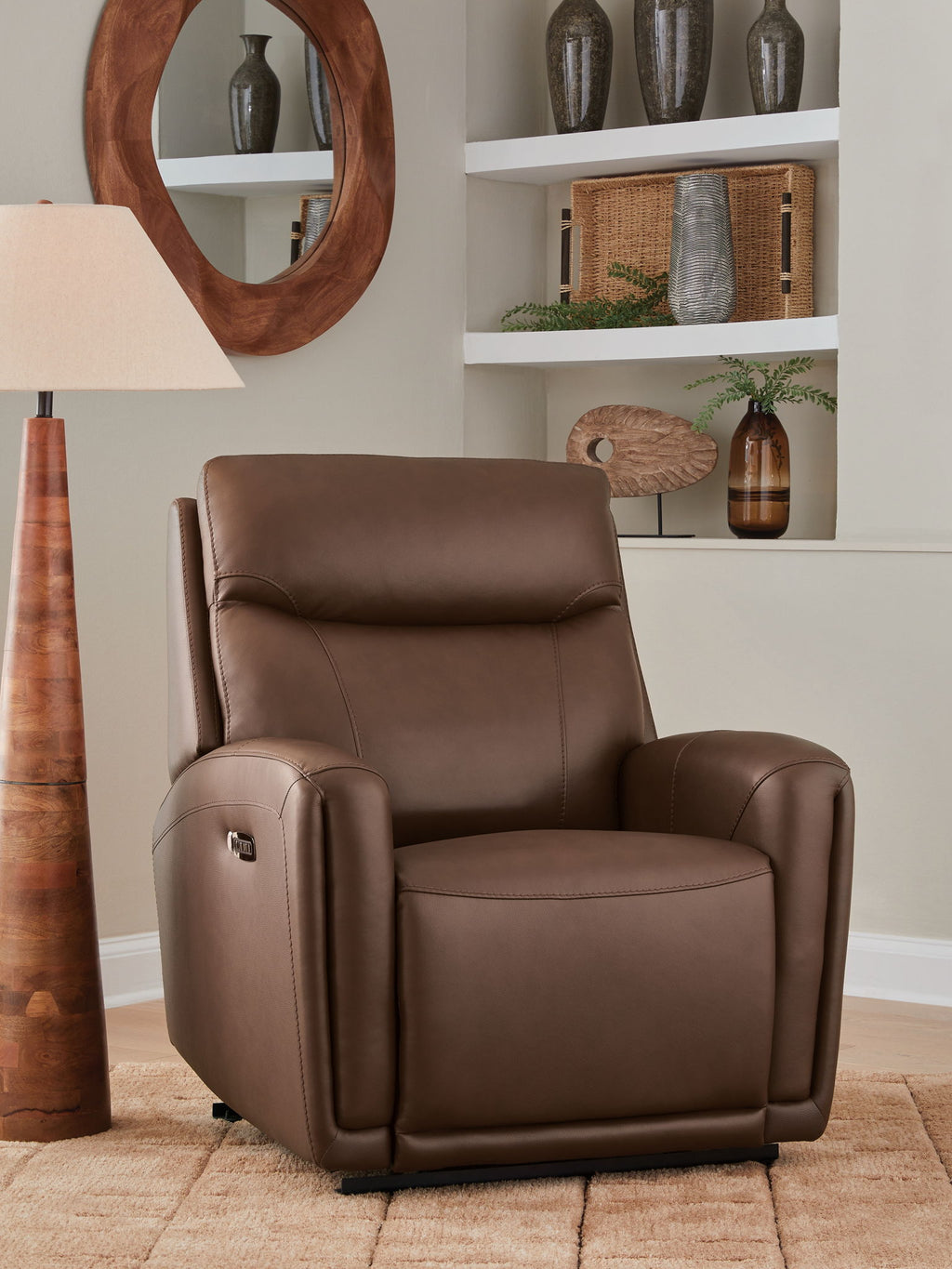 Brown leather-look recliner in upright position with padded headrest and arm storage