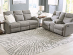 Gray and ivory washable rug in sunburst pattern laid under living room seating