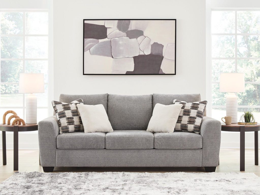 Gray fabric sofa with three seat cushions and check-pattern and cream pillows, wide view