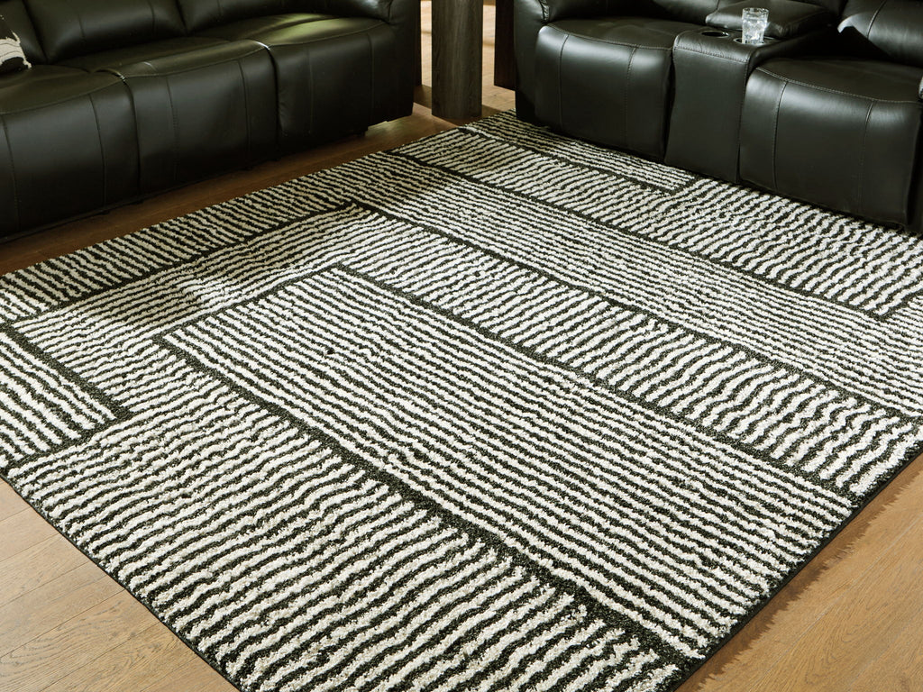 Black-and-white geometric striped rug with contrasting framed square motifs.