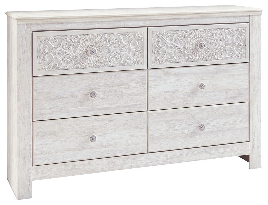 Whitewash six-drawer dresser with raised medallion carvings and round pulls
