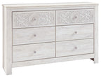 Whitewash six-drawer dresser with raised medallion carvings and round pulls