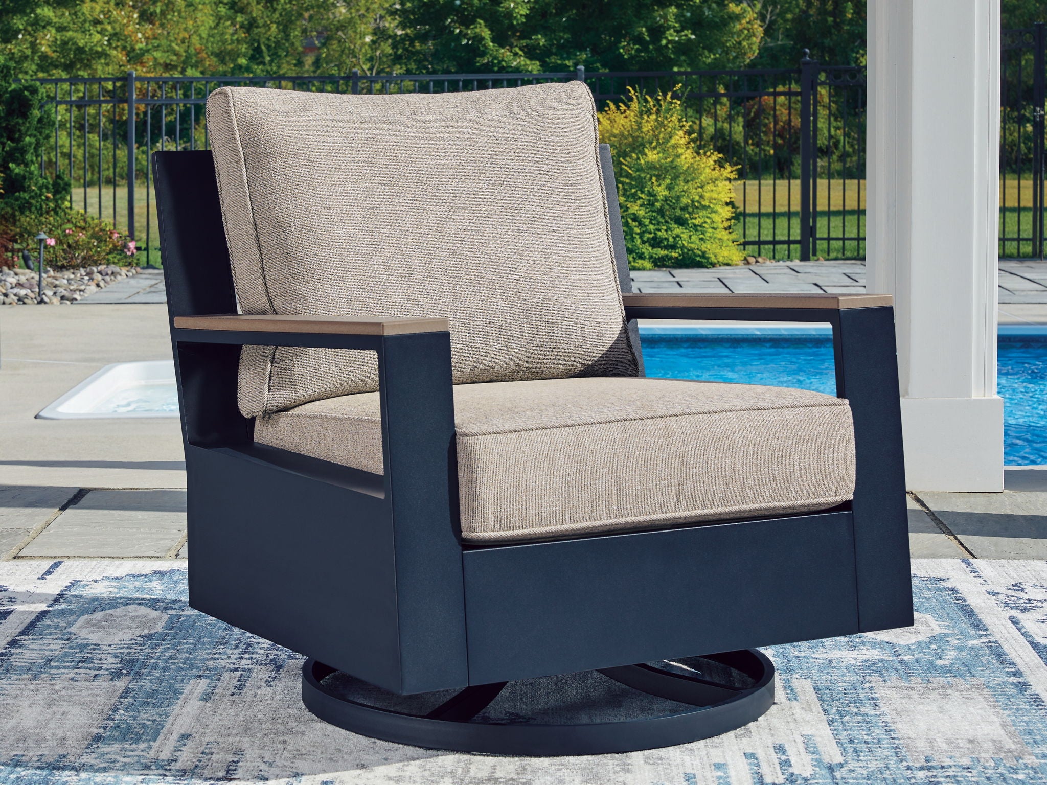 Swivel glider chair with cushion, blue frame with beige seat and back cushion on base