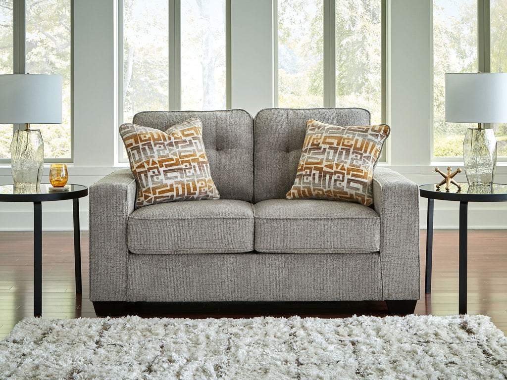 Gray loveseat with two square geometric-pattern throw pillows