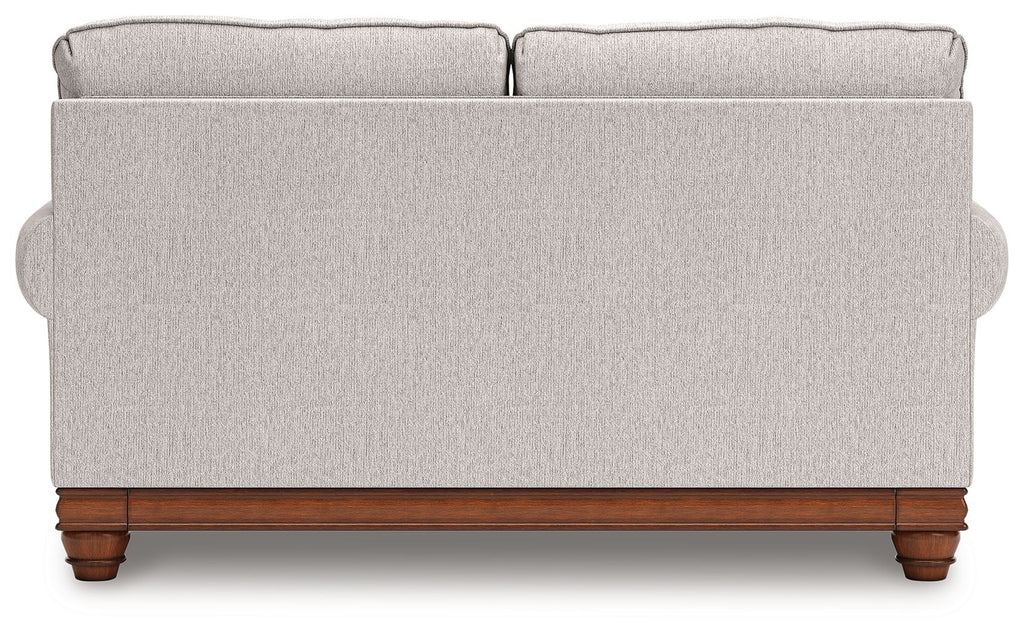 Upholstered loveseat back view with two top cushions and wooden base in light sand
