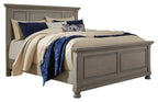 Gray panel bed with upholstered headboard and cream, navy, and patterned bedding