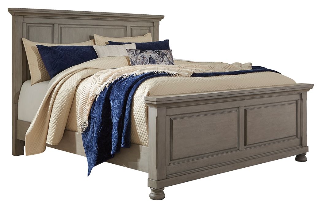Gray panel bed with upholstered headboard and cream, navy, and patterned bedding