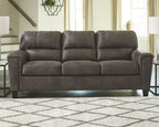 Smoke gray stationary sofa with tufted back cushions and wide padded arms