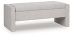 Gray storage bench with tufted upholstered top and hinged lid closed