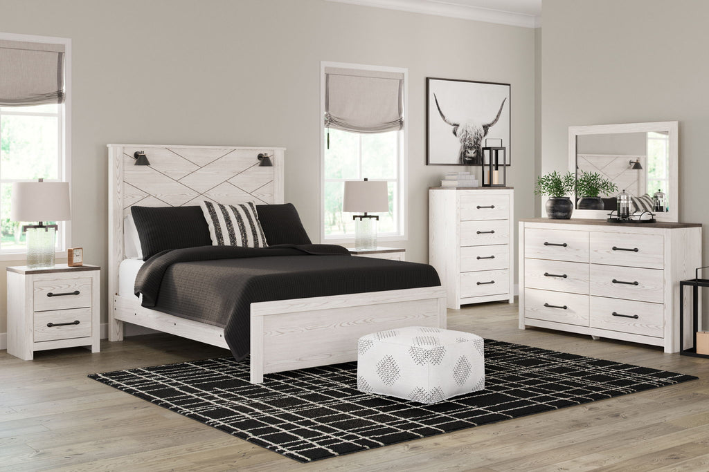 White panel bedroom set with bed, nightstands, dresser, and mirror
