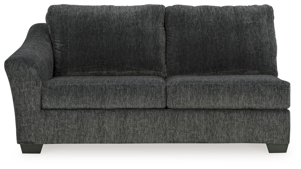 Dark gray upholstered sofa with two seat cushions and back pillows, square arms.
