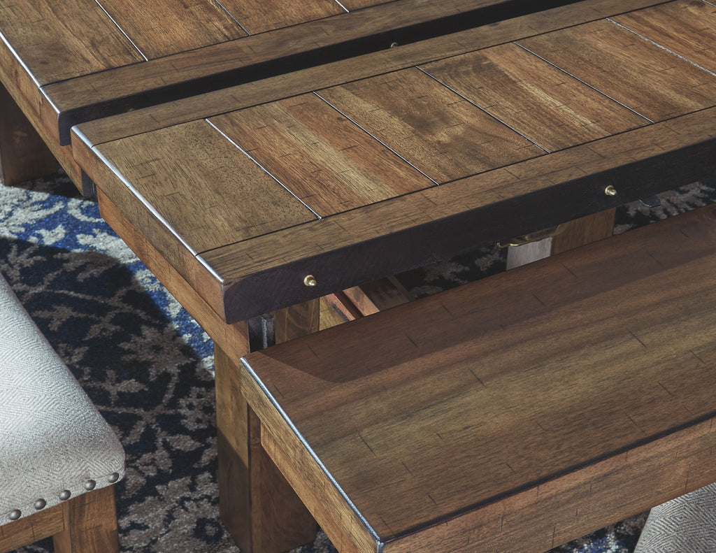 Rectangular dining table close-up with dark wood top, supports, and metal corner hardware