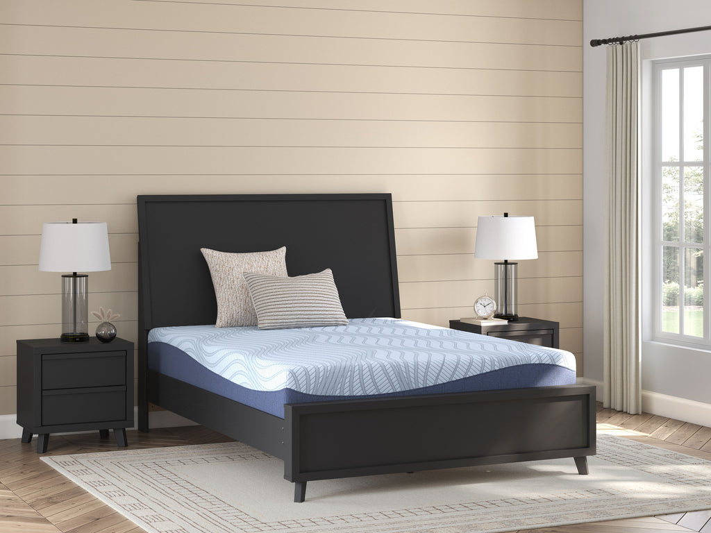 Blue memory foam mattress on a bed frame with a dark blue side panel