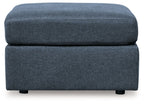Blue upholstered accent ottoman with stacked cube shape and padded seat