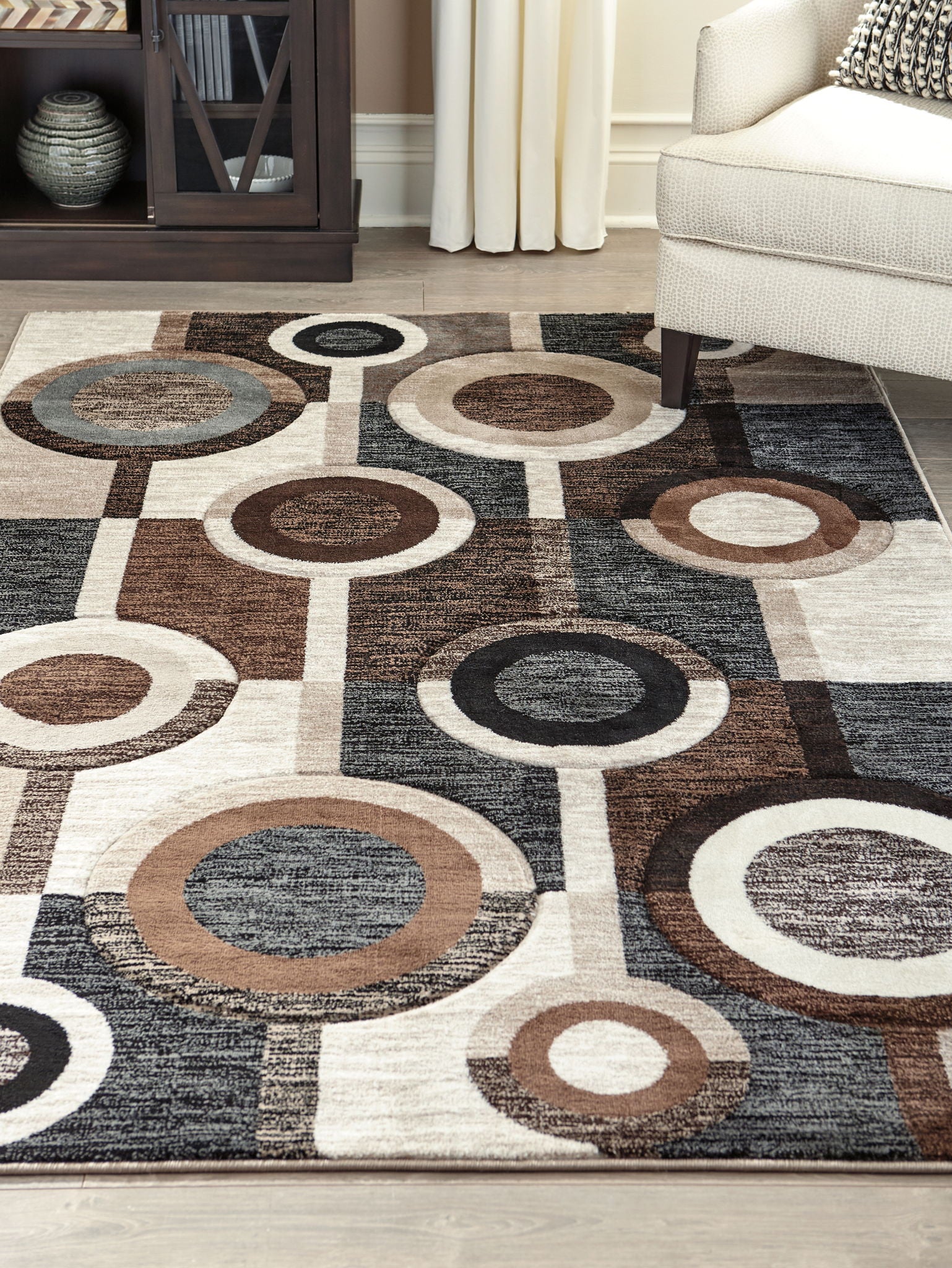 Geometric area rug with ring circle motif in charcoal, dark brown, and cream