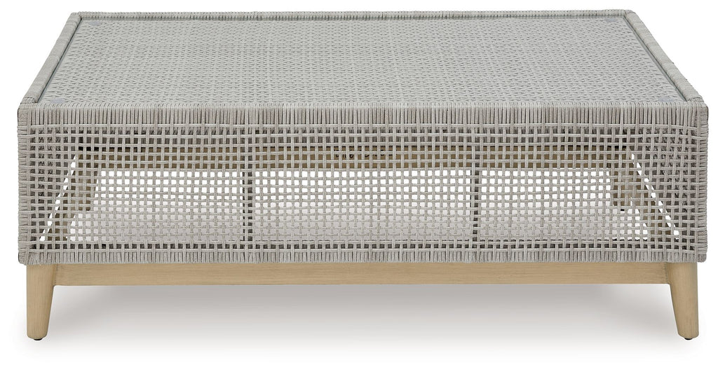 Gray rectangular cocktail table with woven top and open base frame on legs