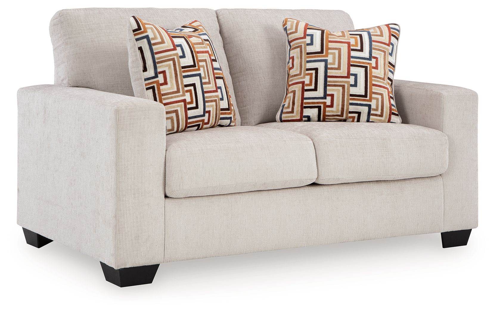 Light gray loveseat with two geometric patterned throw pillows, squared arms