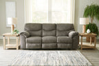 Taupe fabric sofa with three seat cushions and padded, rolled armrests