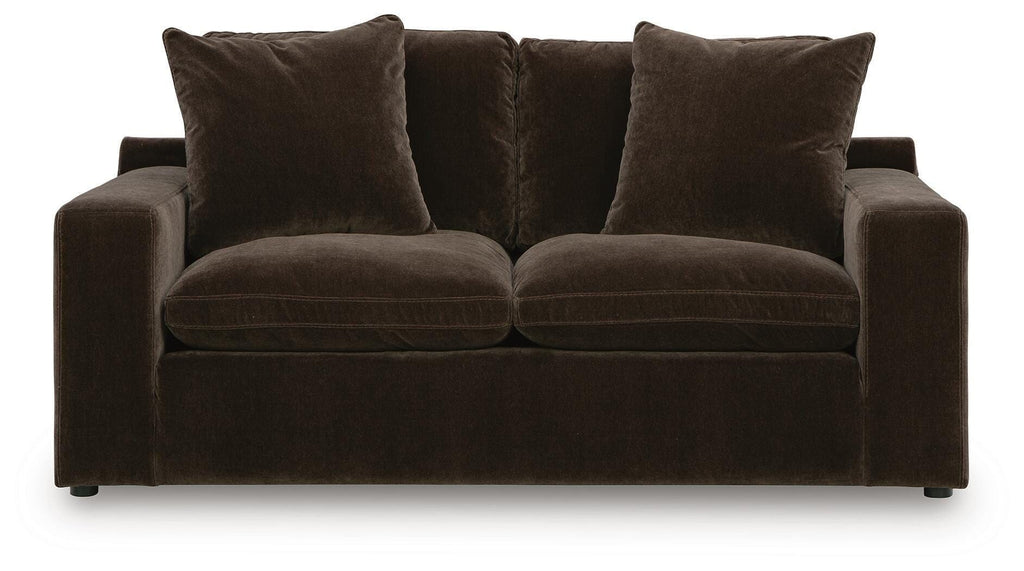 Dark brown loveseat with two seat cushions and four upholstered back pillows