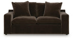 Dark brown loveseat with two seat cushions and four upholstered back pillows