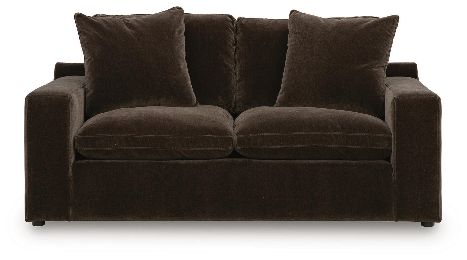 Dark brown loveseat with two seat cushions and four upholstered back pillows