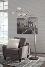 Silver arc floor lamp with five globe bulbs and tall curved metal stand