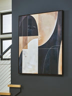 Framed abstract wall art with black, brown, and tan geometric shapes and curved forms