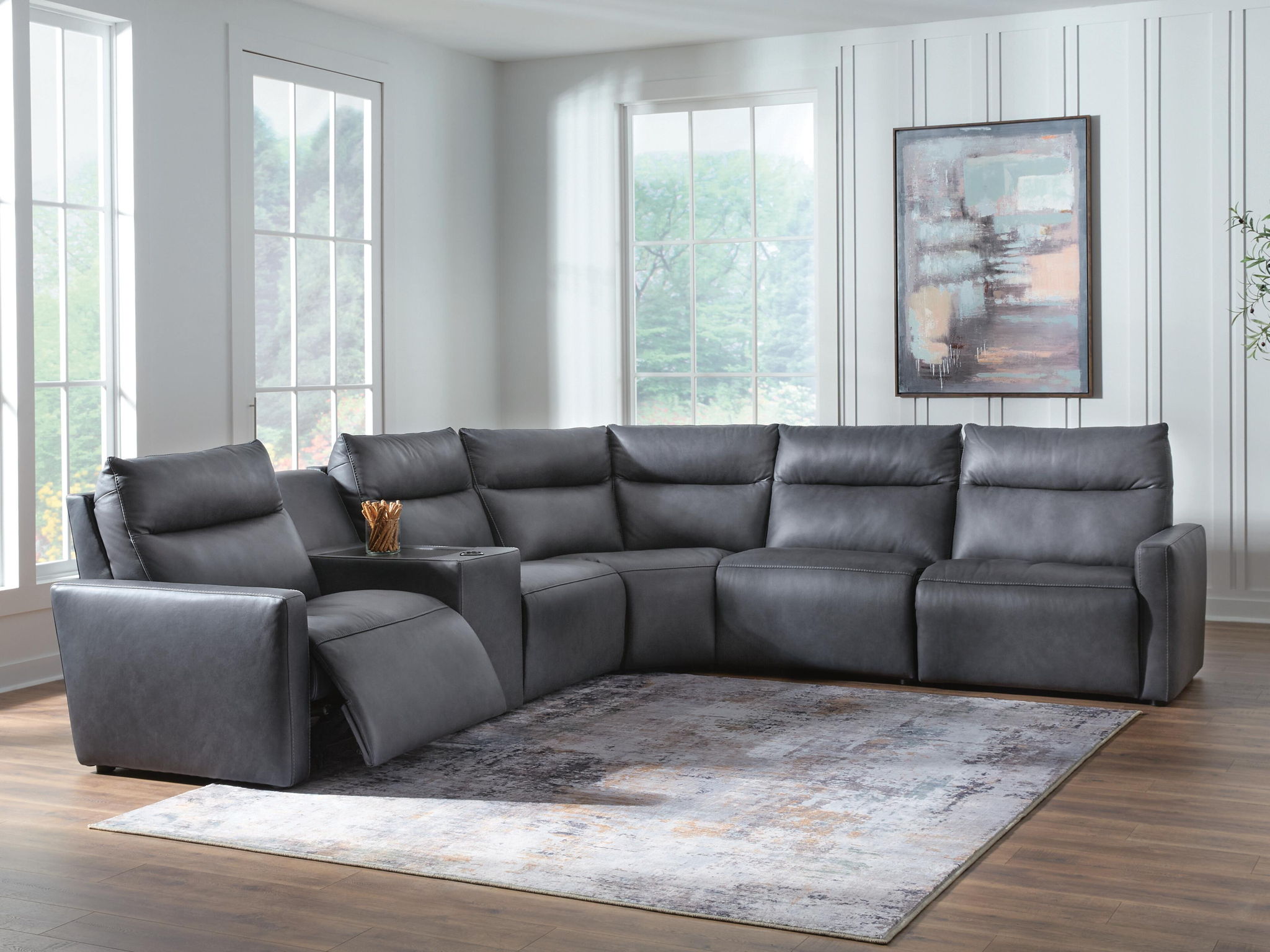 Dark gray power reclining sectional sofa with padded armrests and tufted back cushions
