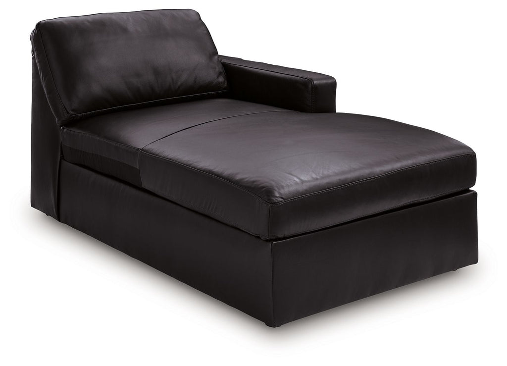 Black corner chaise with padded back, arm, and cushioned seat