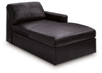 Black corner chaise with padded back, arm, and cushioned seat