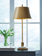 Gold metal floor-style table lamp with wide shade, cylindrical stem, and rounded base