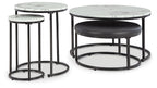 Round black metal nesting tables with white marble-look tops and cushioned bases