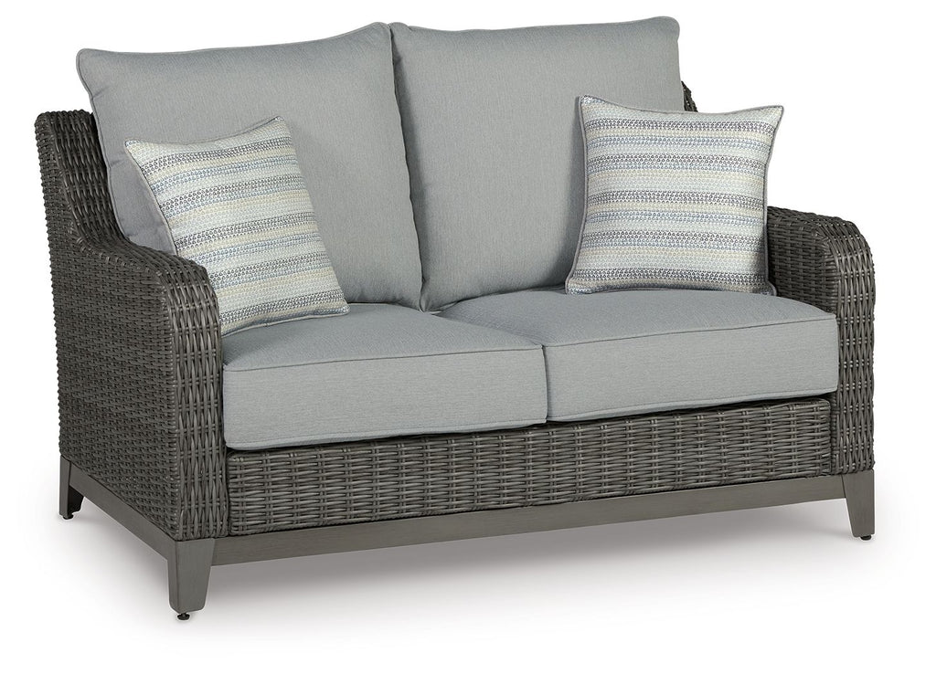 Gray wicker loveseat with two seat cushions, two back cushions, and striped pillows
