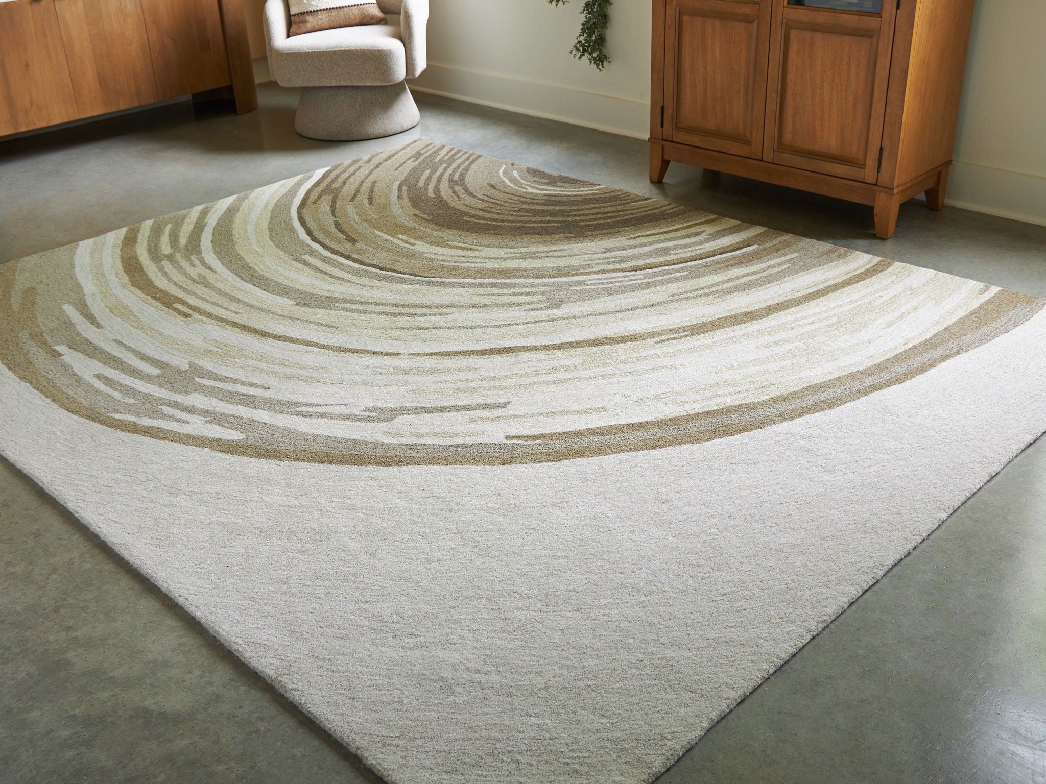 Rug with arced wave stripes in cream and dark olive, textured low pile