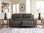 Dark gray power reclining sofa with padded arms and divided seat back sections