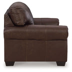 Dark brown loveseat side view with rolled arm and tufted back cushion
