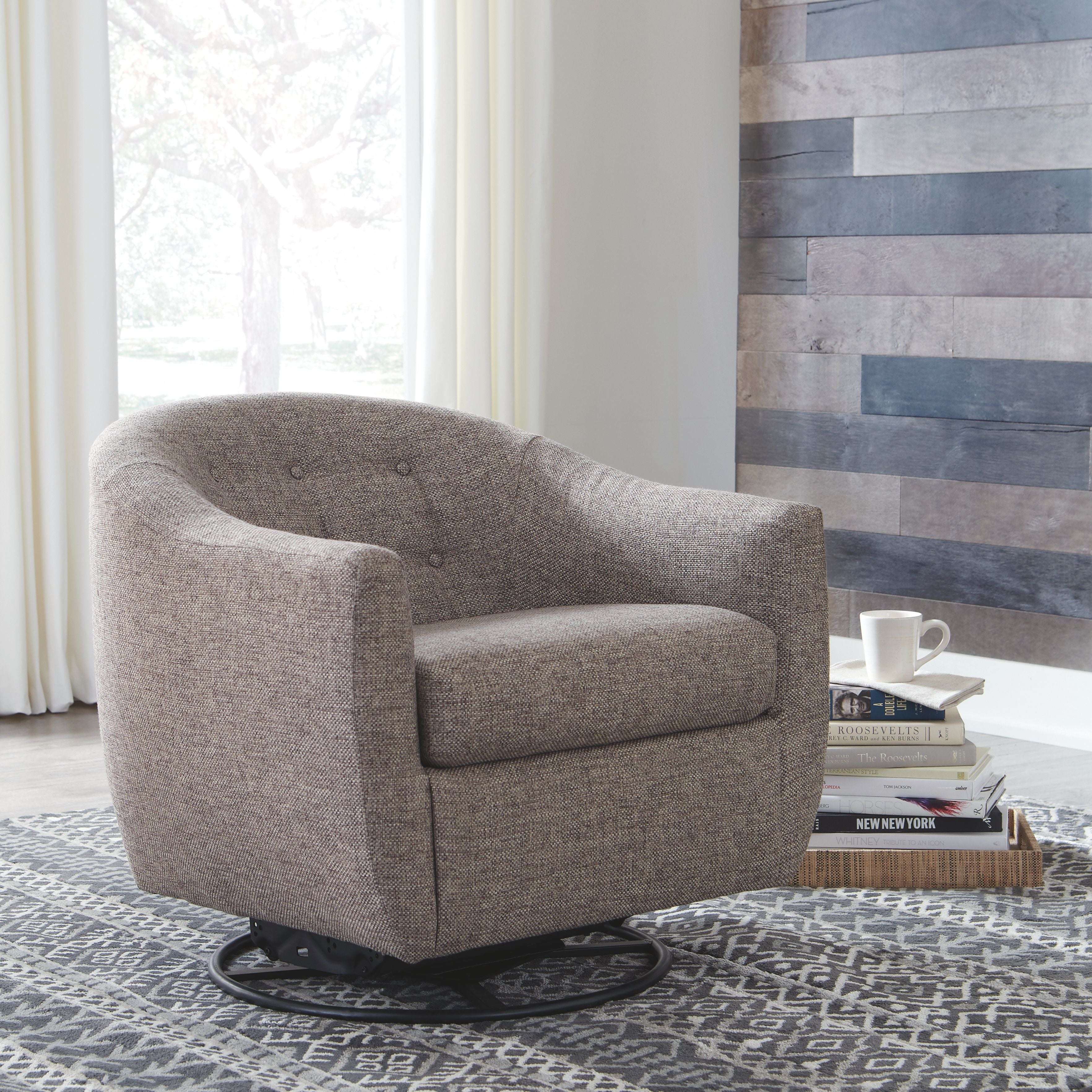 Taupe swivel accent chair with padded armrests, rounded back, and black circular base.