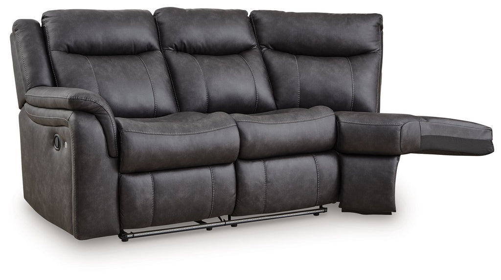 Dark gray reclining loveseat with padded arms, tufted back cushions, and extended footrest