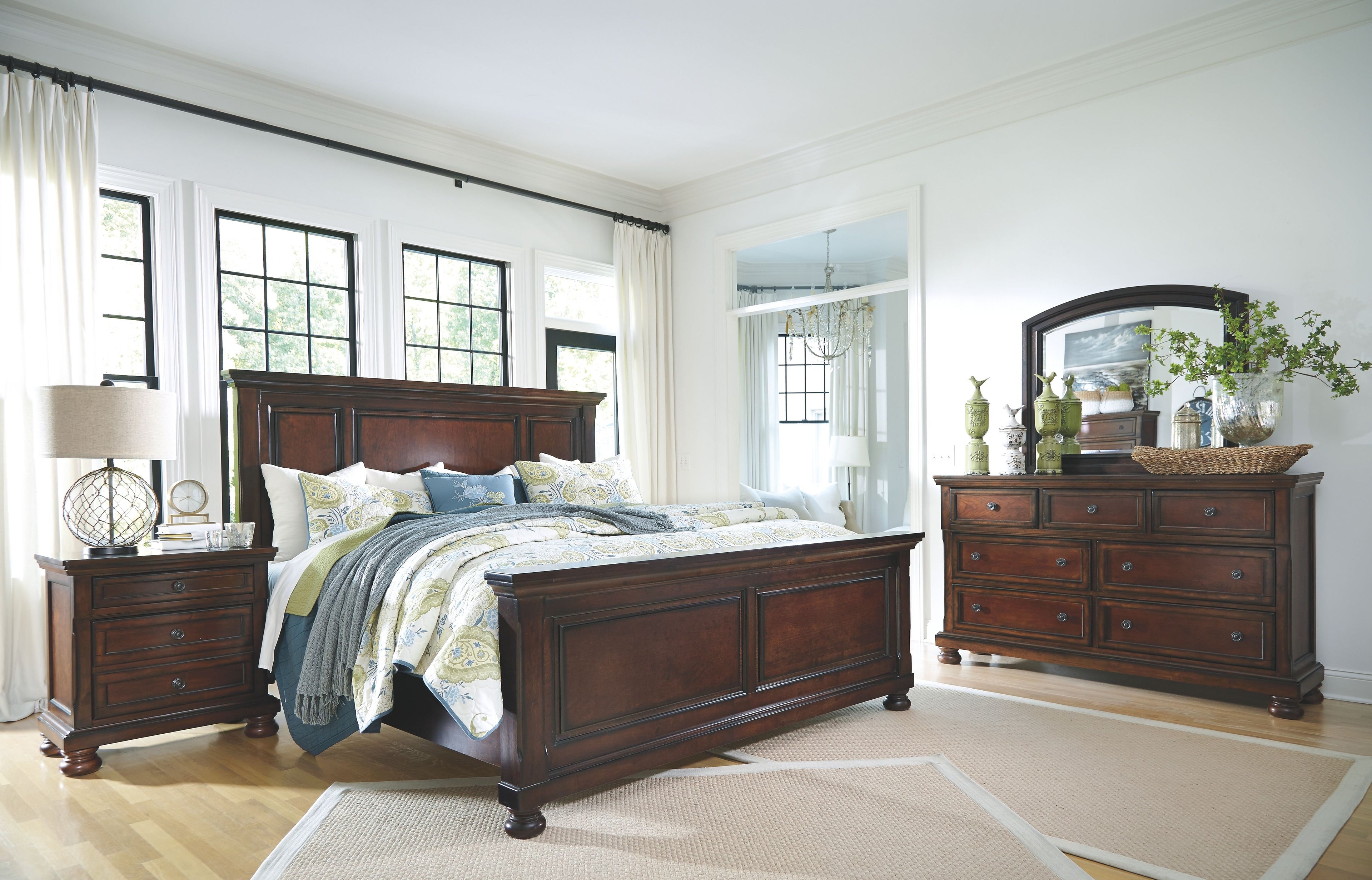 Dark brown bed frame with paneled headboard and footboard, four turned legs