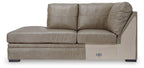 Beige corner chaise sofa with two back cushions, boxy chaise seat, dark base legs.