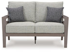 Gray loveseat with two patterned throw pillows, centered back seam, and padded seat cushions