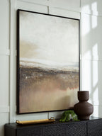 Abstract wall art in a black frame with gray and beige horizon layers