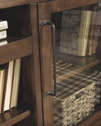 Brown wooden TV stand glass door with metal handle and visible shelf storage